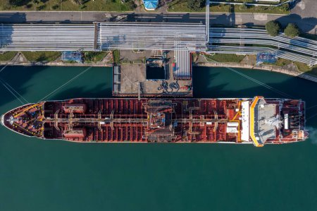 Photo for Overhead shot of large LPG Liquefied Petroleum Gas tanker ship docked at industrial port facility. - Royalty Free Image