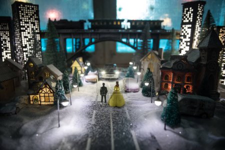 Photo for Little decorative cute small houses in snow at night in winter, Christmas and New Year miniature house in the snow at night with fir tree. Holiday concept. Selective focus - Royalty Free Image