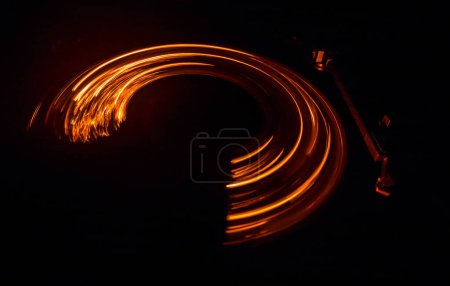 Photo for Music Dj concept. Trail of fire and smoke on vinyl record. Burning vinyl disk. Turntable vinyl record player on dark background. Selective focus - Royalty Free Image