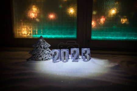 Photo for Happy New Year 2023. Traditional holiday attributes on snow. A greeting card for Christmas. Selective focus - Royalty Free Image
