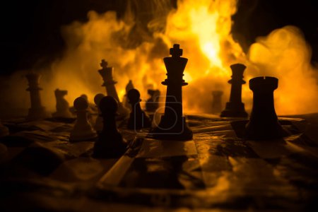 Photo for Chess board game concept of business ideas and competition or war theme. Chess figures on a dark background of explosion and fire clouds. Selective focus - Royalty Free Image