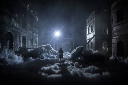 Photo for War apocalypse concept. Snow covered ruined city destroyed by war. Refugees and civilians silhouettes on dark. Creative artwork decoration in dark. Selective focus - Royalty Free Image