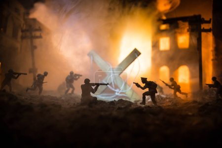 Photo for Concept of war or manipulation with global politics. The puppeteer controls soldiers. Night battle scene. Military fighting silhouettes in destroyed city. Selective focus - Royalty Free Image