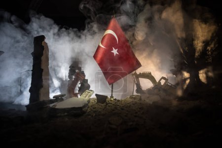 Foto de Turkey Earthquake happend in February 2023. Decorative photo with Turkish flag, and ruined city buildings. Pray for Turkey. Selective focus - Imagen libre de derechos