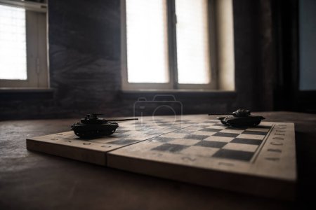 Photo for War between Russia and Ukraine, conceptual image of war using chess board and tank on a dark background. Ukrainian and Russian crisis, political conflict. Selective focus - Royalty Free Image
