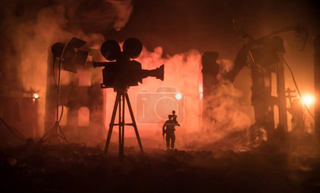 Foto de Action (War) movie concept. Man moving out with little boy from burned out city destroyed in war. Military fighting silhouettes. Selective focus - Imagen libre de derechos