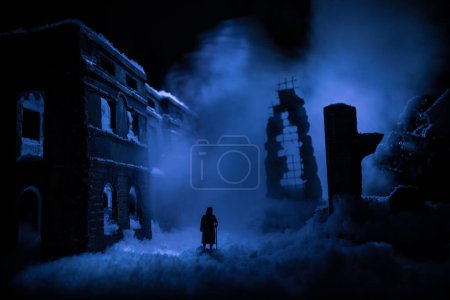 Photo for War apocalypse concept. Snow covered ruined city destroyed by war. Refugees and civilians silhouettes on dark. Creative artwork decoration in dark. Selective focus - Royalty Free Image