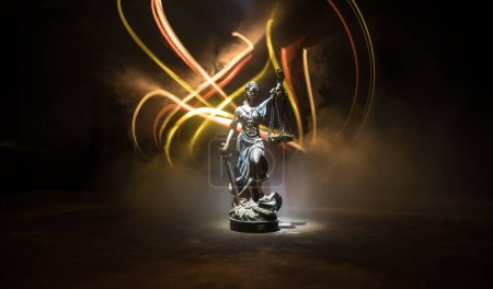 Photo for No law or dictatorship concept. The Statue of Justice with anti-riot police helmet holding scale. Creative artwork decoration with colorful toned foggy background. Selective focus - Royalty Free Image