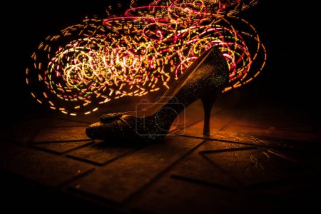 Photo for Artwork decoration. Silhouette of a high heel women shoes at dark. Women power or women domination concept. Selective focus - Royalty Free Image
