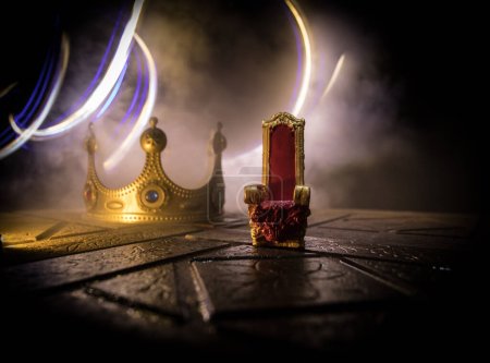 Photo for Red royal chair miniature on wooden table. Place for the king. Medieval Throne. Selective focus - Royalty Free Image
