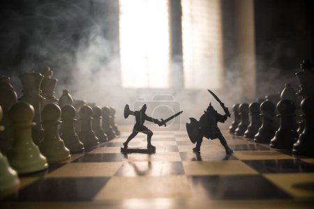 Photo for Medieval battle scene with cavalry and infantry on chessboard. Chess board game concept of business ideas and competition and strategy ideas Chess figures on a dark background with smoke and fog. - Royalty Free Image