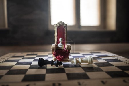 Photo for Red royal chair (Medieval Throne) miniature on chessboard. . Chess board game concept of business ideas and competition and strategy ideas concept. Selective focus - Royalty Free Image
