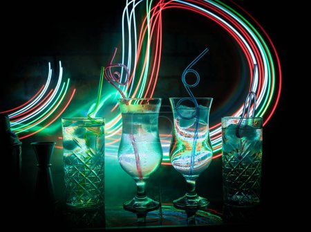 Photo for Colorful cocktail in glass on dark background or Glasses of cocktails on bar background.Party club entertainment. Mixed light - Royalty Free Image