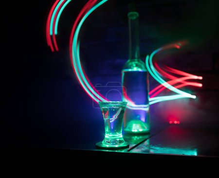 Photo for Cold vodka glass on a dark background in the neon light or glasses of russian vodka on bar background. selective focus - Royalty Free Image
