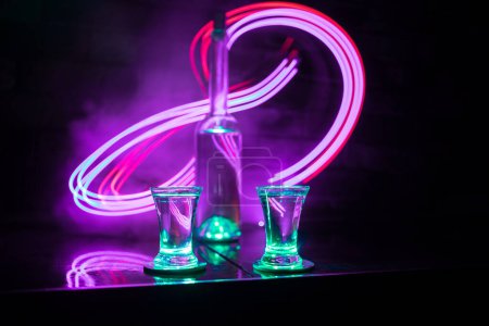 Photo for Cold vodka glass on a dark background in the neon light or glasses of russian vodka on bar background. selective focus - Royalty Free Image