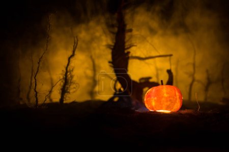 Photo for Horror view of hanged girl on tree at night Suicide decoration. Death punishment executions or suicide abstract idea. Halloween pumpkin head jack lantern on background - Royalty Free Image