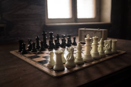 Photo for Chess board game concept of business ideas, competition and strategy. Chess figures on a dark background with smoke and fog. Selective focus - Royalty Free Image