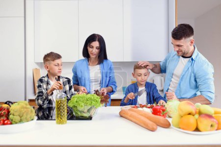 Happy stylish family with two kids preparing healthy vegetarian breakfast with and vegetables on cozy kitchen.