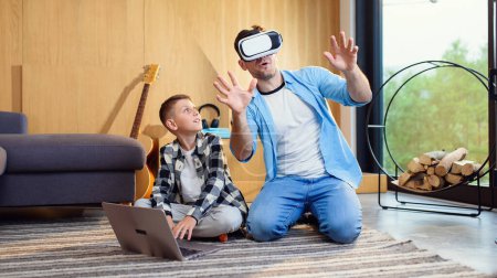 Photo for Happy father and son testing virtual reality headset playing augmented video reality games. - Royalty Free Image
