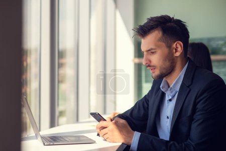 Photo for Young businessman talking on the phone at the office. - Royalty Free Image
