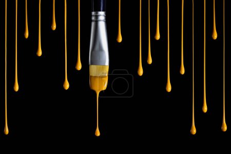 Photo for Old paintbrush dripping yellow paint isolated over white background - Royalty Free Image