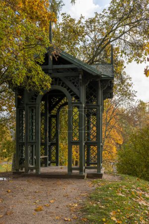 Panoramic view of wooden openwork gazebo in public park in autumn, Cesis, Latvia