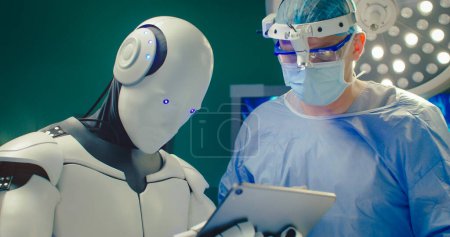 Foto de Robot realiza una operación quirúrgica en un hospital moderno. Trabajo en equipo de cirujanos médicos profesionales en quirófano. Proporcionar tratamiento con inteligencia artificial. Concepto de medicina moderna. - Imagen libre de derechos