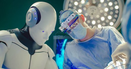Foto de Futuro concepto de cirugía robótica. Sala de cirugía en el hospital con equipo de tecnología robótica. Cirujano robot en quirófano futurista. Innovación quirúrgica mínimamente invasiva. - Imagen libre de derechos