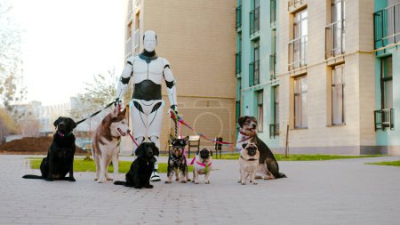 White cyborg worker standing and looking at camera with group of various breed dogs on fresh air. Replacement of human labor with robotics. Futuristic services.