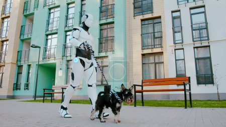 Side view of happy scottish terrier dog walking with humanoid robot cyborg with leash on street outdoors. Concept of technology evolution, domestic animals and futuristic technology.