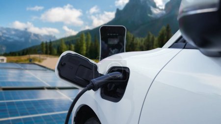 Concept of progressive future renewable and clean energy technology by charging station recharge EV cars battery powered by solar cell for eco-friendly sustainable energy system.