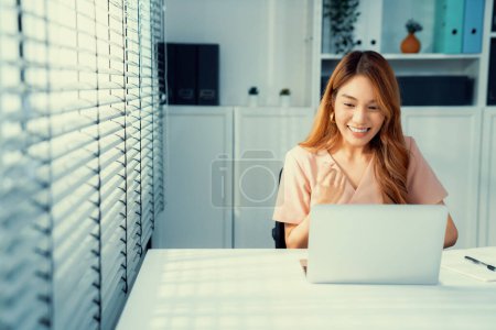 A young female employee receives a promotion, good news or finished her task and overjoyed for being a competent worker.