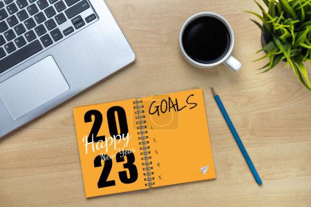 2023 Happy New Year Resolution Goal List and Plans Setting - Business office desk with notebook written about plan listing of new year goals and resolutions setting. Change and determination concept.