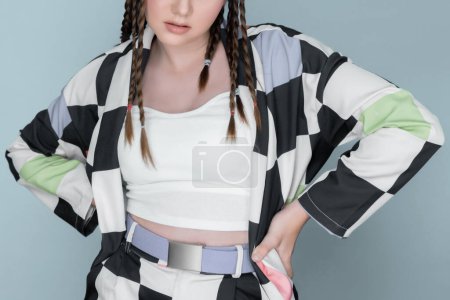 Closeup beautiful young girl with perfect skin, cosmetic and long braid posing with trendy fashion outfit in the studio with isolated background. charming young teenage with beauty gesture.