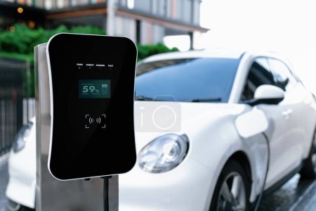Foto de Focus electric home charging station powered from green energy at home for vehicle engine. Progressive eco friendly energy rechargeable for vehicle concept. - Imagen libre de derechos