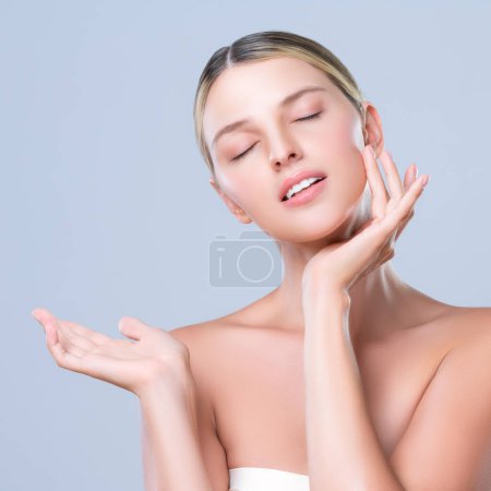 Photo for Alluring beautiful woman with perfect smooth and clean skin portrait in isolated background. Beauty hand gesture with expressive facial expression for skincare treatment product or spa. - Royalty Free Image