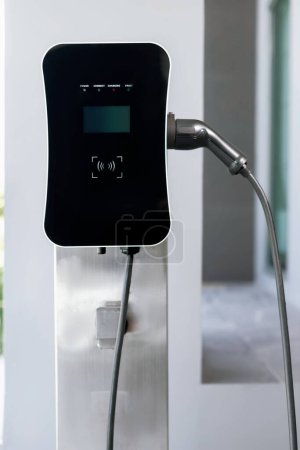 Foto de Progressive green energy-powered charging station concept for electric vehicle connected to home charging station at the garage or backyard. Eco friendly rechargeable car powered by clean energy. - Imagen libre de derechos