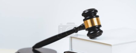 Photo for Closeup wooden gavel hammer and law book in empty law firm or white lawyer office background as justice and legal system by lawyer and judge, Legal authority and fairness in trial concept. equility - Royalty Free Image