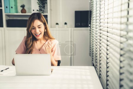 A young female employee receives a promotion, good news or finished her task and overjoyed for being a competent worker.