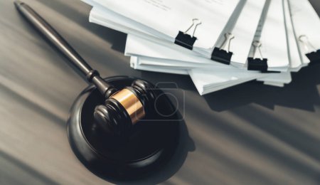Photo for Closeup top view black wooden gavel hammer and legal document on wooden office desk background as justice and legal system for lawyer and judge, Legal authority and fairness in trials. equility - Royalty Free Image