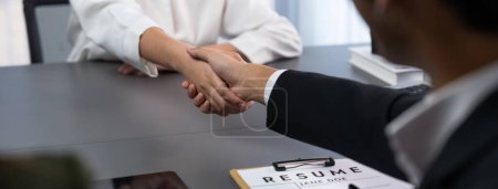 Photo for Successful job interview at business office end with handshake as the hired candidate seals the deal with the HR team recruiter by handshaking after successful interview. Panorama shot. Prodigy - Royalty Free Image