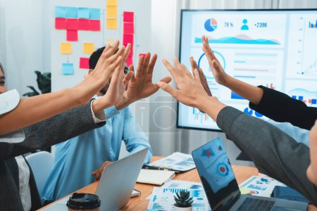 Photo for Diverse business team celebrate successful meeting with high-fives and expressions of happiness in corporate office meeting represent unity success and professional integrity. Concord - Royalty Free Image