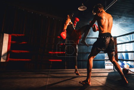 Photo for Asian and Caucasian Muay Thai boxer unleash knee attack in fierce boxing training session, delivering knee strike to sparring trainer, showcasing Muay Thai boxing technique and skill. Impetus - Royalty Free Image