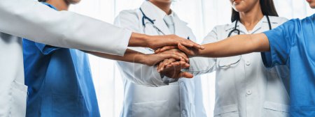 Group of medical staff doctor nurse and healthcare specialist profession coordinating synergy hand in hospital. Medical teamwork and healthcare cooperation in panoramic banner background. Neoteric