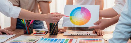 Photo for Graphic designer brainstorm logo and graphic art at busy creative studio workshop. Experiment and brainstorm color palette and pattern at workspace table for creative design. Panorama shot. Scrutinize - Royalty Free Image