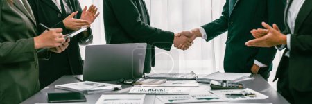Photo for Analyst team handshake after successful planning business marketing with handshake. Panorama shot group of business people handshaking after successful business negotiation in meeting room. Prodigy - Royalty Free Image