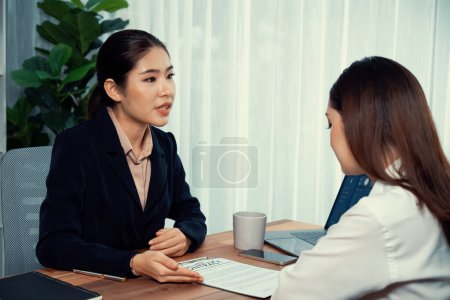 Photo for Business deal meeting, young businesswomen carefully reviewing terms and condition of contract agreement papers in office. Corporate lawyer give consultation on contract deal. Enthusiastic - Royalty Free Image