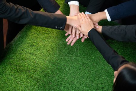Photo for Business synergy of business people holding hand together as team building for eco regulation for environmental protection by reducing CO2 emission to contribute sustainable future. Quaint - Royalty Free Image