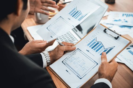 Photo for Diverse group of business analyst team analyzing financial data report paper on office table. Chart and graph dashboard by business intelligence analysis for strategic marketing planning Meticulous - Royalty Free Image