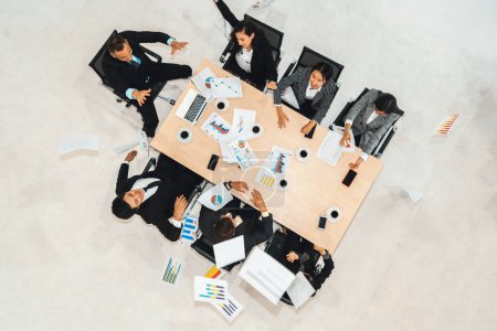 Photo for Successful business people celebrate together with joy at office table shot from top view . Young businessman and businesswoman workers express cheerful victory showing success by teamwork . Jivy - Royalty Free Image
